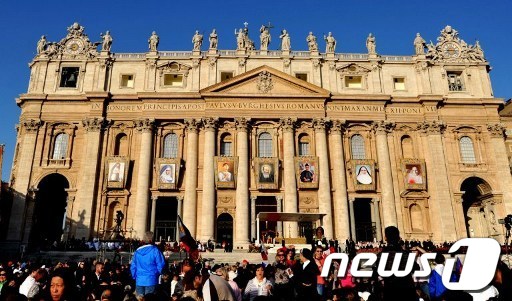 21일 바티칸의 성 베드로 대성당 건물 외벽에 7명 성인 초상화가 걸려 있다. © AFP=News1  