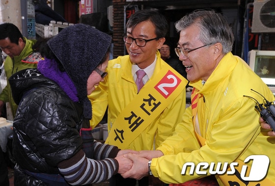 2012년 3월 13일 민주통합당 문재인 상임고문(부산 사상)이 19대 총선에 출마한 전재수 후보(북강서갑)의 지역구인 부산 북구 구포시장을 방문해 상인들과 악수하고 있다. 전 후보는 19대 총선에서 낙마했지만 20대부터 22대까지 내리 3선에 성공했다. ⓒ 뉴스1 DB