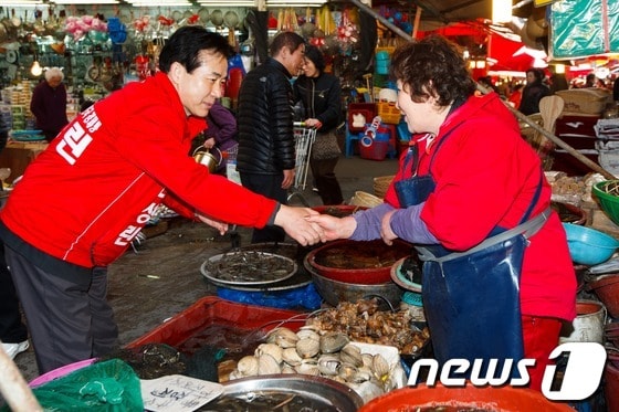 나성린 새누리당 후보가 부산 부전시장에서 상인들과 인사를 나누고 있다. © News1 유승관 기자