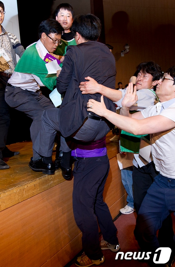 12일 오후 경기 고양 일산 킨텍스에서 열린 통합진보당 2012 제1차 중앙위원회서 통합진보당 당원들과 당권파 중앙위원들이 '불법중앙회 중단'을 외치며 의장석 진입을 시도하고 있다. © News1 이명근 기자