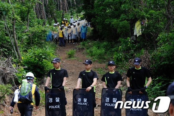한전이 경남 밀양지역 765㎸ 송전탑 공사를 재개한 20일 오전 밀양 부북면 위양리 평밭마을 127 송전탑 공사현장에 한전 직원과 경찰이 길을 막아서고 있다. 2013.5.20/뉴스1 © News1 전혜원 기자
