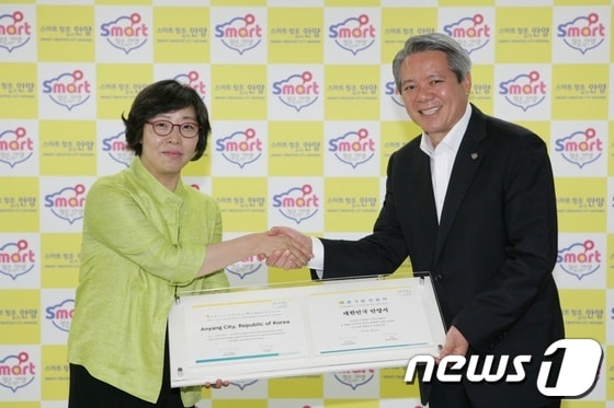 최대호 안양시장(오른쪽)이 20일 안양시청에서 박연희 ICLEI 한국사무소 소장으로부터 ICLEI 가입 인증서를 받은 뒤 악수를 나누고 있다./사진제공=안양시© News1