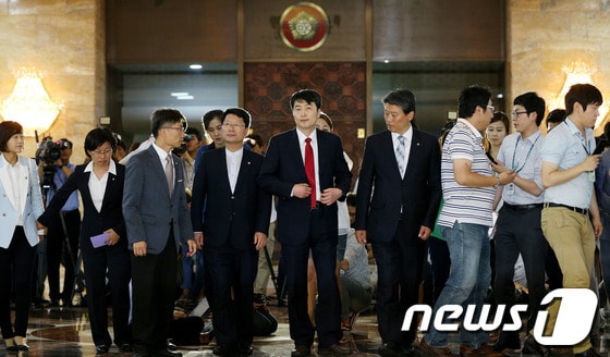 내란음모 혐의를 받고 있는 이석기 통합진보당 의원(가운데)이 2일 오후 서울 여의도 국회에서 열린 9월 정기국회 개회식에 참석하며 현 상황에 대한 입장을 밝힌 뒤 돌아서서 본회의장으로 입장하고 있다. 2013.9.2/뉴스1 © News1 오대일 기자