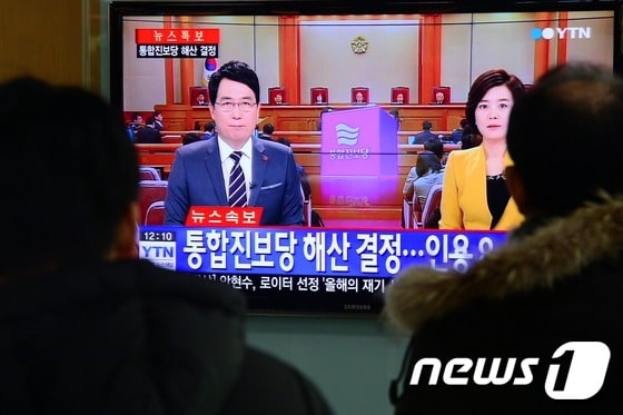 헌법재판소가 통합진보당 해산 결정을 내린 19일 오후 서울 중구 회현동 서울역 대합실에서 시민들이 관련 뉴스를 시청하고 있다. 2014.12.19/뉴스1 ⓒ News1 정회성 기자