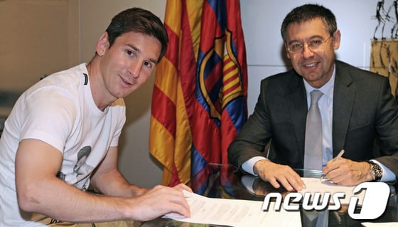 FC바르셀로나와 재계약을 체결한 리오넬 메시가 20일(한국시간) 구단 사무실에서 연봉 계약 체결 후 포즈를 취하고 있다. .© AFP=News1