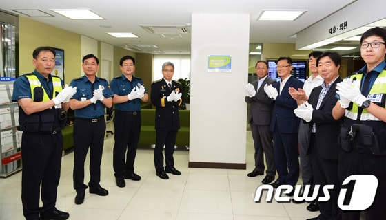 박도영 부산중부경찰서장(왼쪽 네 번째)이 24일 오후 2시 BNK부산은행 대창동지점에서 전화금융사기 예방 우수 금융기관 인증패 부착식에 참석해 축하 박수를 치고 있다.(부산중부경찰서 제공)2017.8.24./뉴스1 ⓒ News1