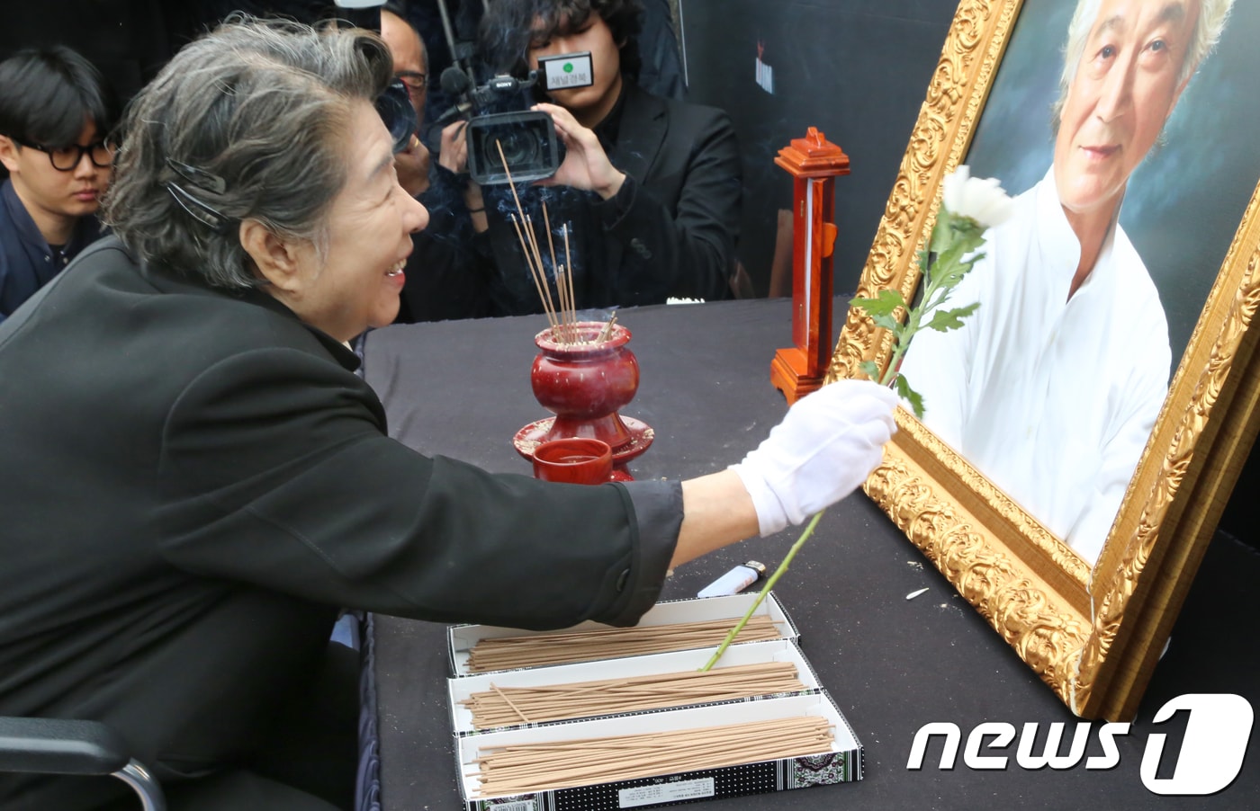 7일 경북 영천시 괴연동 성일가에서 열린 故 신성일 추모제에서 부인 엄앵란씨가 신성일씨의 영정을 흰국화로 쓰다듬고 있다. 고인의 유언에 따라 그의 유해는 자신이 살던 집 앞 마당에 묻혔다. 故신성일은 60-70년대 은막을 주름잡았던 한국 최고의 영화배우이자 국민배우로 그가 출연한 영화만 500편이 넘는다.2018.11.7/뉴스1 ⓒ News1 정우용 기자