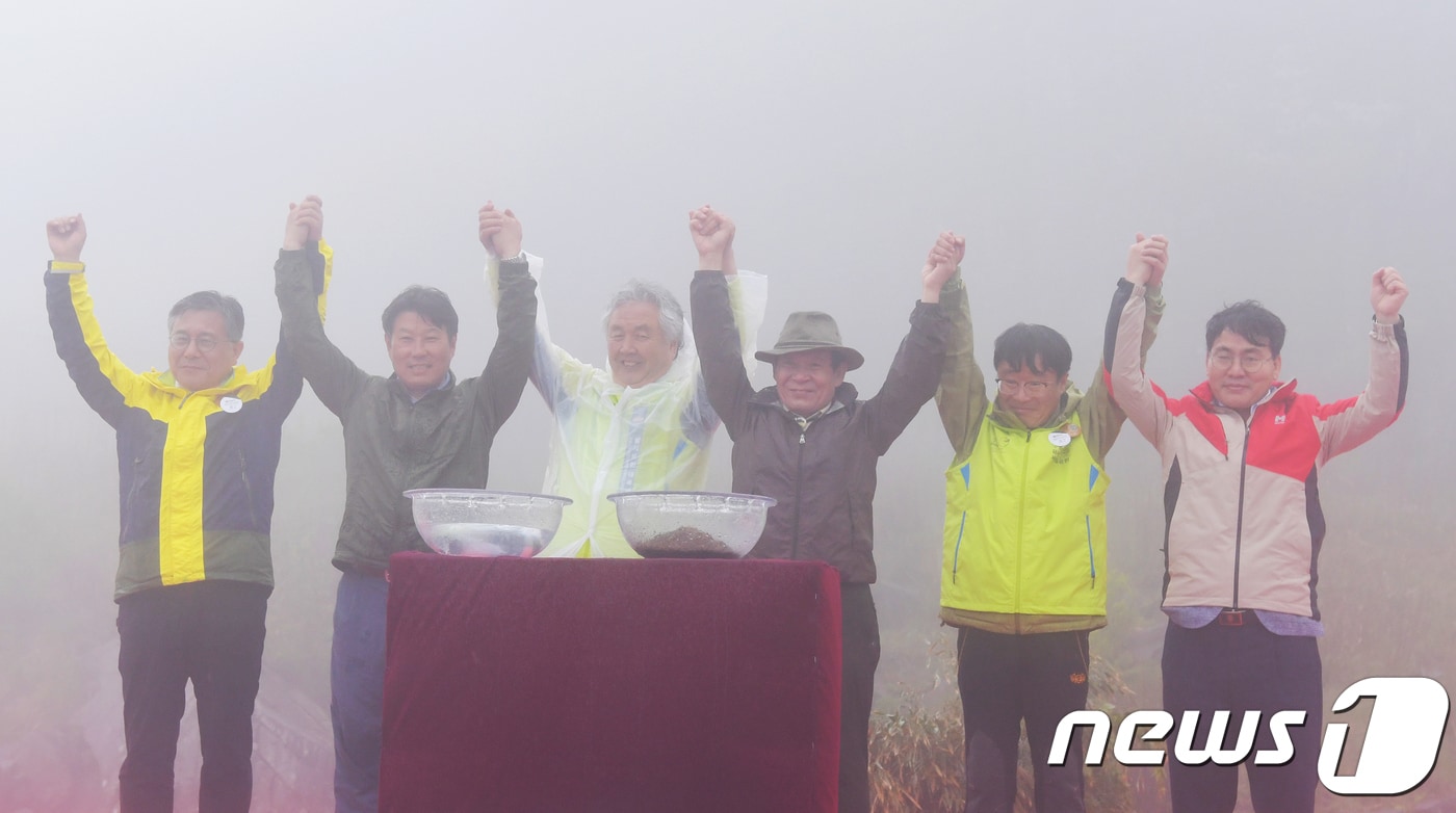 윤장현 광주시장(오른쪽 세 번째)과 이재영 전남도지사 권한대행(오른쪽 첫번째) 등이 12일 오전 무등산 정상 지왕봉에서 열린 '무등산권 유네스코 세계지질공원 인증 기념 무등산 정상개방' 행사에서 손을 맞잡고 있다. 왼쪽부터 무등산권지질관광사업단 허민 단장, 조용익 담양군수 권한대행, 무등산보호단체협의회 채정기 상임의장, 윤장현 광주시장, 정병석 전남대 총장, 이재영 전남도지사 권한대행.(광주시 제공)2018.5.12/뉴스