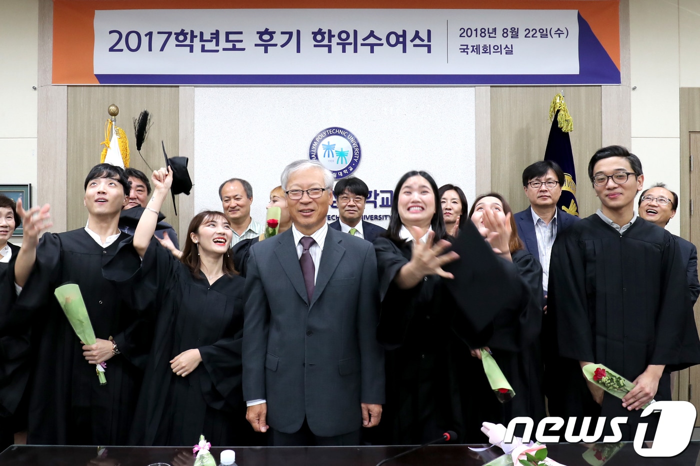 우형식 총장과 졸업생 26명이 22일 오전 대학 국제회의실에서 열린 2017학년도 후기 학위수여식에서 기념사진을 촬영하고 있다. (한림성심대 제공) 2018.8.22/뉴스1 ⓒ News1 김경석 기자