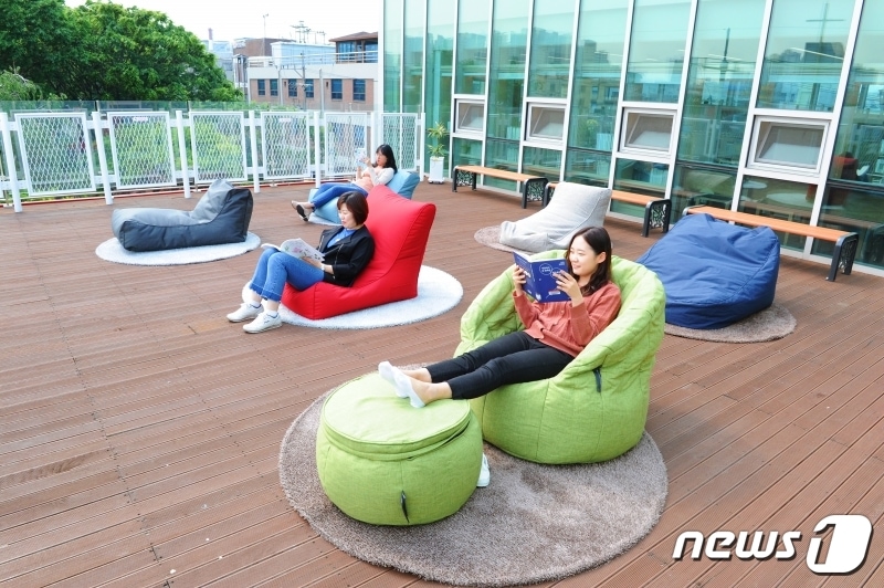 신흥 어울마당 작은도서관 야외 공간에서 시민들이 책을 읽고 있다.(부천시제공) ⓒ 뉴스1