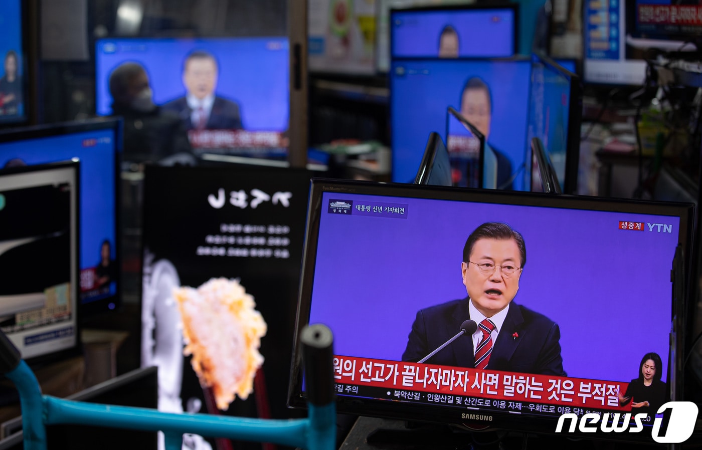 18일 서울 황학동 시장에서 한 상인이 문재인 대통령의 신축년(辛丑年) 기자회견을 TV를 통해 지켜보고 있다. 2021.1.18/뉴스1 ⓒ News1 이재명 기자