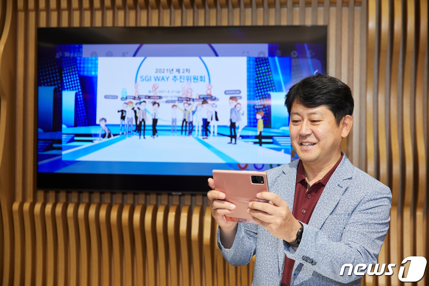 서울보증보험 유광열 대표이사가 휴대전화를 이용해 지난 8월 27일 메타버스 플랫폼에서 개최된 회의에 참석하고 있다.ⓒ 뉴스1