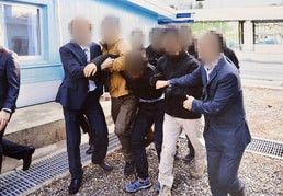 통일부가 공개한 북한 선원 북송 모습. 북한 선원 2명이 2019년 11월 판문점을 통해 추방되고 있다. 2022.7.12/뉴스1