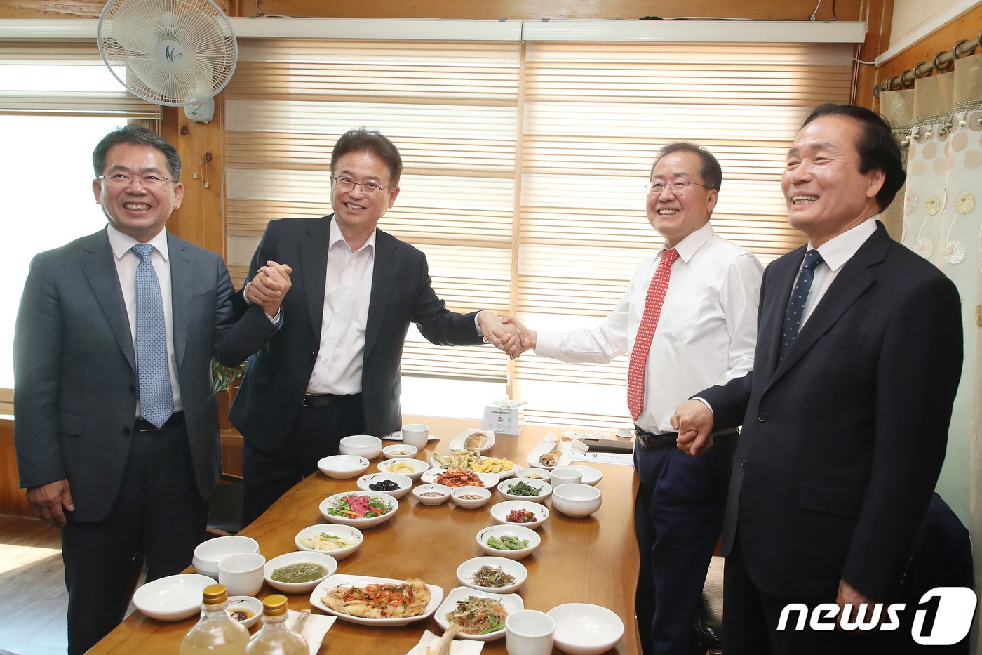 김진열 군위군수, 이철우 경북도지사, 홍준표 대구시장, 김주수 의성군수(왼쪽부터)가 28일 오전 경북 군위군의 한 한정식집에서 열린 대구경북신공항 성공적인 건설을 위한 화합 간담회에 참석해 함께 손잡고 환하게 웃고 있다. 2023.4.28/뉴스1 ⓒ News1 공정식 기자