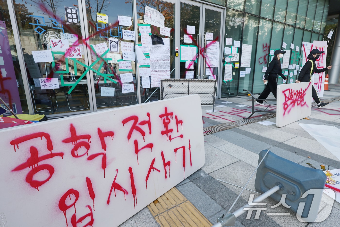 12일 서울 성북구 동덕여자대학교 백주년기념관에 학생들이 학교 측의 남녀공학 전환 논의를 규탄하며 붉은색 래커 스프레이로 적은 항의 문구가 선명히 남아 있다. 이날 학생들은 학교 측에 공학 전환 완전 철회를 비롯해, 총장직선제 등을 촉구하며 수업 거부 및 시위 등을 이어갈 것이라 밝혔다. 2024.11.12/뉴스1 ⓒ News1 민경석 기자