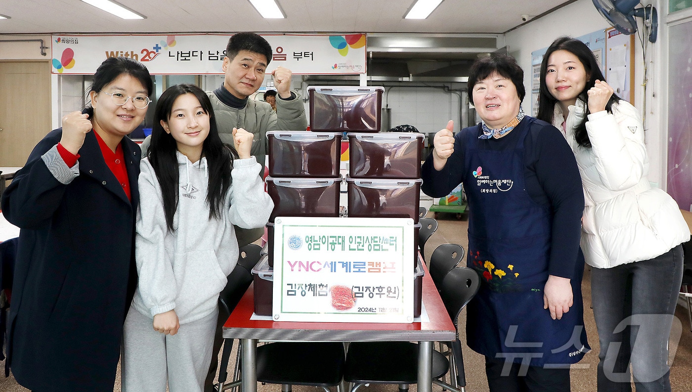 영남이공대 교수와 학생들이 교내 &#39;YNC 세계로 캠프 김장 나눔&#39;을 통해 담근 김장 김치를 대구 남구 경로급식소 &#39;희망의 집&#39;에 전달한 뒤 기념촬영을 하고 있다. &#40;영남이공대 제공&#41;