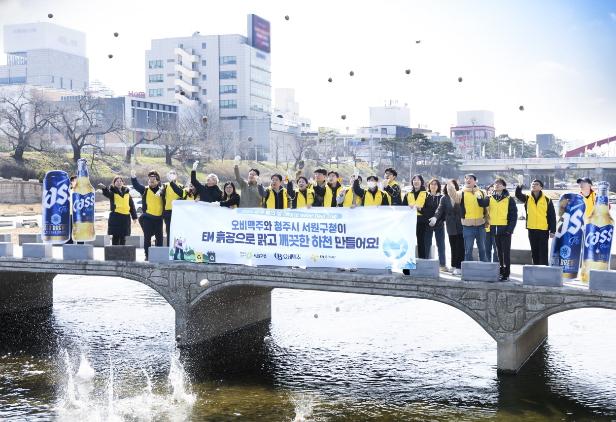 21일 오비맥주 청주공장 임직원들이 서원구청 관계자들과 청주시 무심천에서 환경 정화 활동을 한 뒤 기념사진을 촬영하고 있다.&#40;오비맥주 제공&#41;