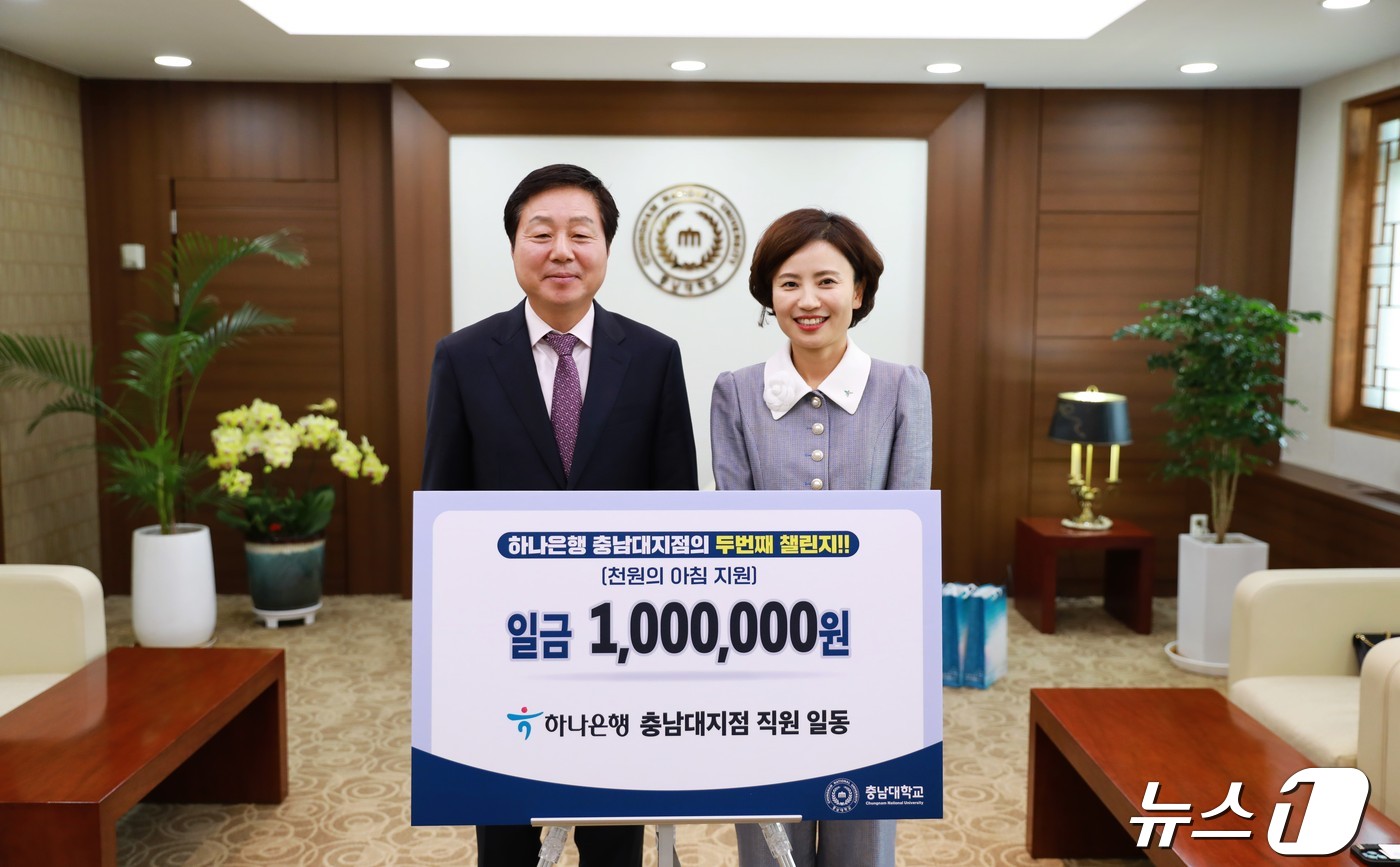 26일 충남대에서 김정겸 총장(왼쪽)이 우미현 하나은행 충남대지점장에게 '천원의 아침밥' 사업 기부금 100만 원을 전달받은 뒤 기념사진을 찍고 있다. (충남대 제공)/뉴스1