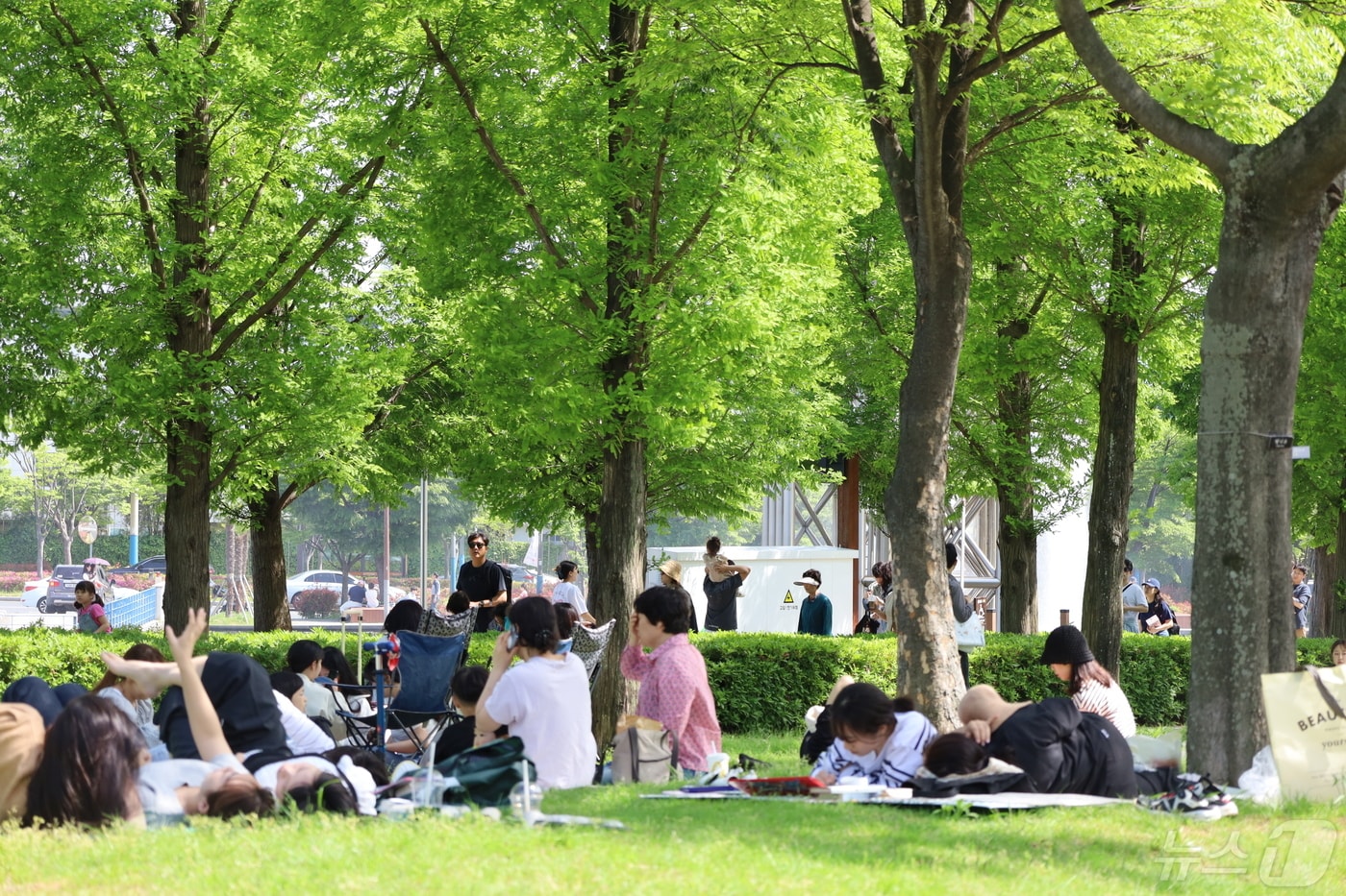 어린이날 연휴 첫날인 4일 오후 부산시민공원을 찾은 나들이객이 나무그늘 아래서 쉬고 있다.2024.5.4. 손연우 기자