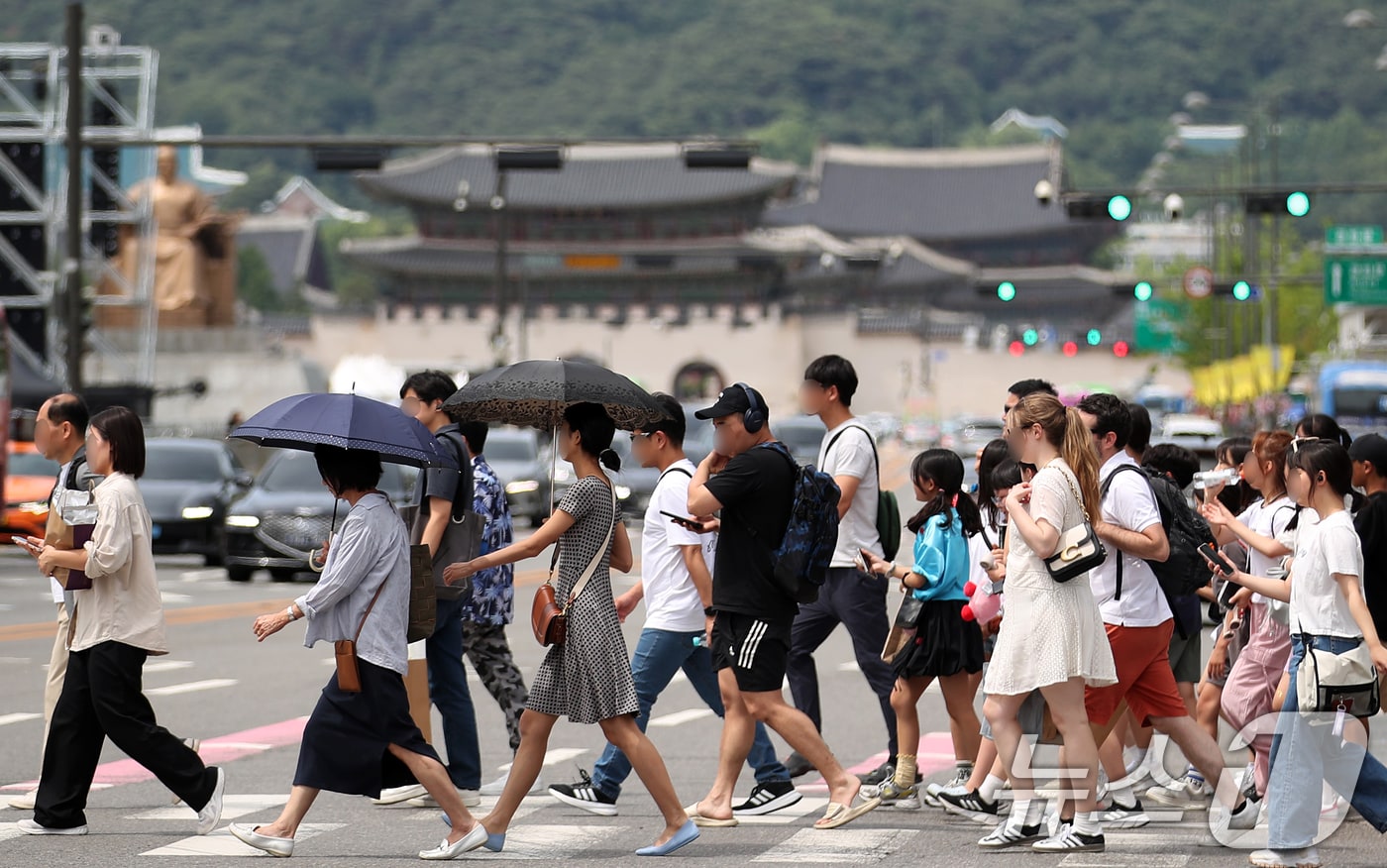 양산으로 햇볕을 가린 채 걷고 있는 사람들.(사진은 기사 내용과 무관함) / 뉴스1 ⓒ News1