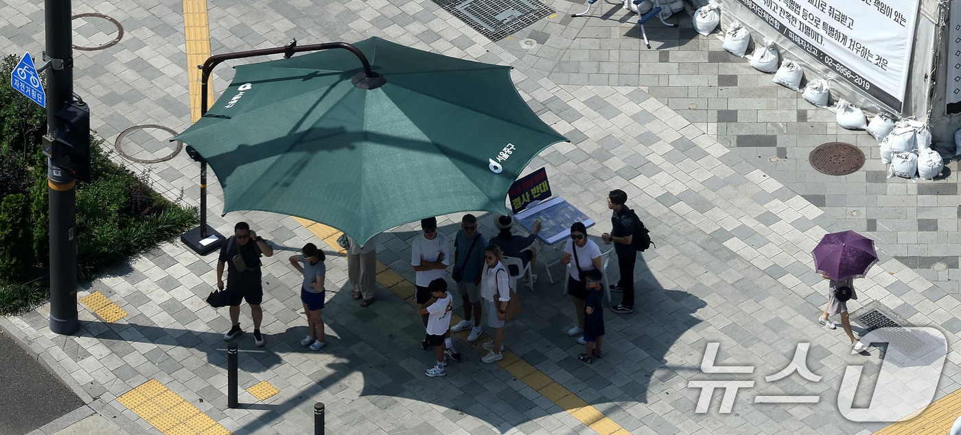 서울 시청역 인근 그늘막 아래에서 시민들이 건널목 신호를 기다리고 있다. 2024.8.20/뉴스1 ⓒ News1 박지혜 기자