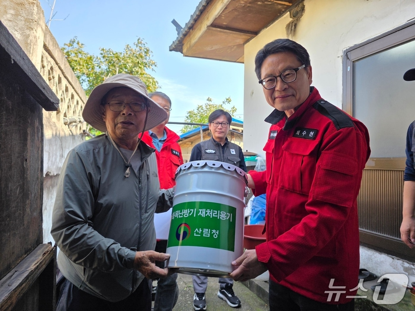 최수천 동부지방산림청장(사진 오른쪽)이 화목 사용 농가에 재처리용기를 지급하고 있다.(동부산림청 제공, 재판매 및 DB 금지) 2025.10.2/뉴스1