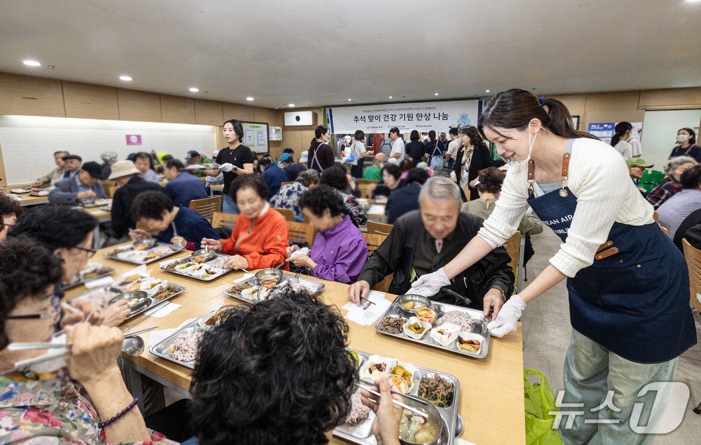 대한항공-아시아나항공 양사 임직원들이 서울 강서구 지역 어르신들에게 추석 음식을 대접하고 있다.(대한항공 제공) 