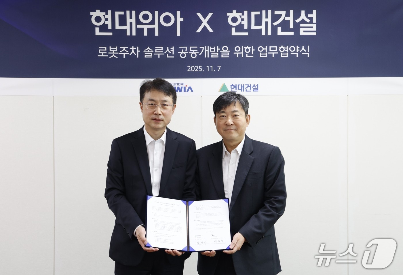 현대위아 모빌리티솔루션사업부 백익진 상무(왼쪽)와 현대건설 기술연구원 김재영 원장이 7일 경기도 의왕시 현대위아 의왕연구소에서 열린 ‘로봇 친화형 주차솔루션 공동개발을 위한 업무협약식’에서 기념 사진을 찍고 있다. (현대위아 제공)