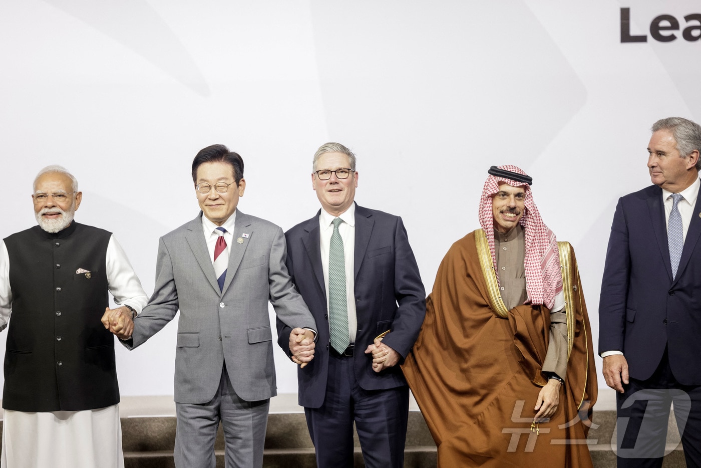 22일&#40;현지시간&#41; 남아공 요하네스버그에서 열린 주요 20개국&#40;G20&#41;에서 정상들이 단체 사진을 촬영했다. 사진은 이재명 대통령이 나렌드라 모디 인도 총리&#40;왼쪽 첫번째&#41;, 키어 스티머 영국 총리&#40;가운데&#41;와 손을 잡고 있는 모습. 우측엔 파이살 빈 파르한 알 사우드 왕자 사우디아라비아 외교부 장관, 파블로 키르노 아르헨티나 외교부 장관이다. ⓒ 로이터=뉴스1 ⓒ News1 최종일 선임기자