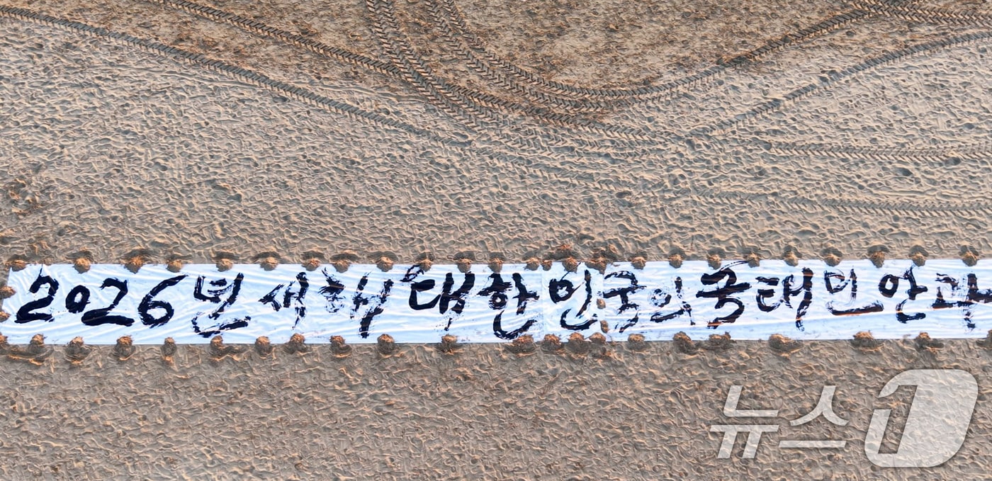 독도 서예가로 알려진 김동욱 씨가 지난 26일 포항 송도해수욕장 백사장에서 길이 50m 광목천에 새해 국민의 행복을 기원하는 글을 쓰는 퍼포먼스를 펼쳤다.(김동욱 씨 제공, 재판매 및 DB금지) 2025.12.29/뉴스1 ⓒ News1 최창호 기자
