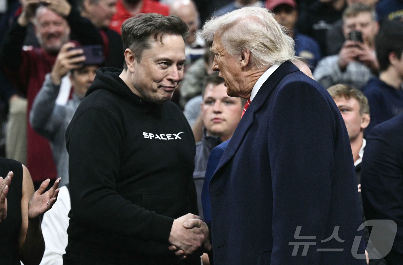 도널드 트럼프 미국 대통령과 일론 머스크 테슬라 최고경영자(CEO)가 지난 3월 펜실베이니아주 필라델피아 웰스파고 센터에서 열린 스포츠 행사에서 만나 악수하고 있다. ⓒ AFP=뉴스1 ⓒ News1 류정민 특파원