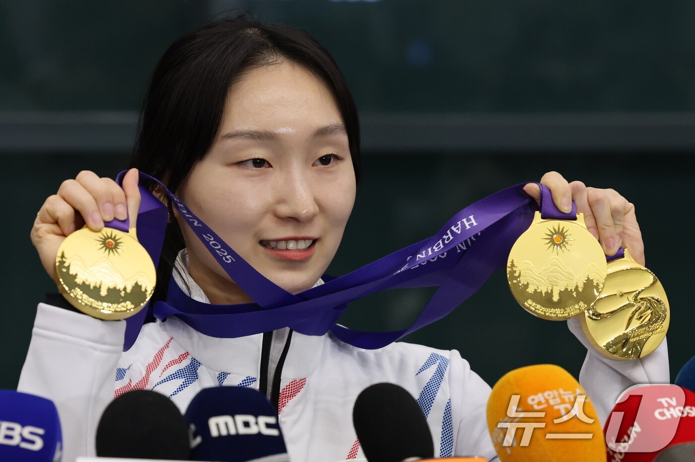 2025 하얼빈 동계아시안게임에서 3관왕을 차지한 쇼트트랙 최민정이 10일 오후 인천국제공항을 통해 귀국 후 금메달을 들어보이고 있다. 쇼트트랙 국가대표팀은 이번 대회에서 금메달 6개, 은메달 4개, 동메달 3개를 수확했다. 2025.2.10/뉴스1 ⓒ News1 박세연 기자