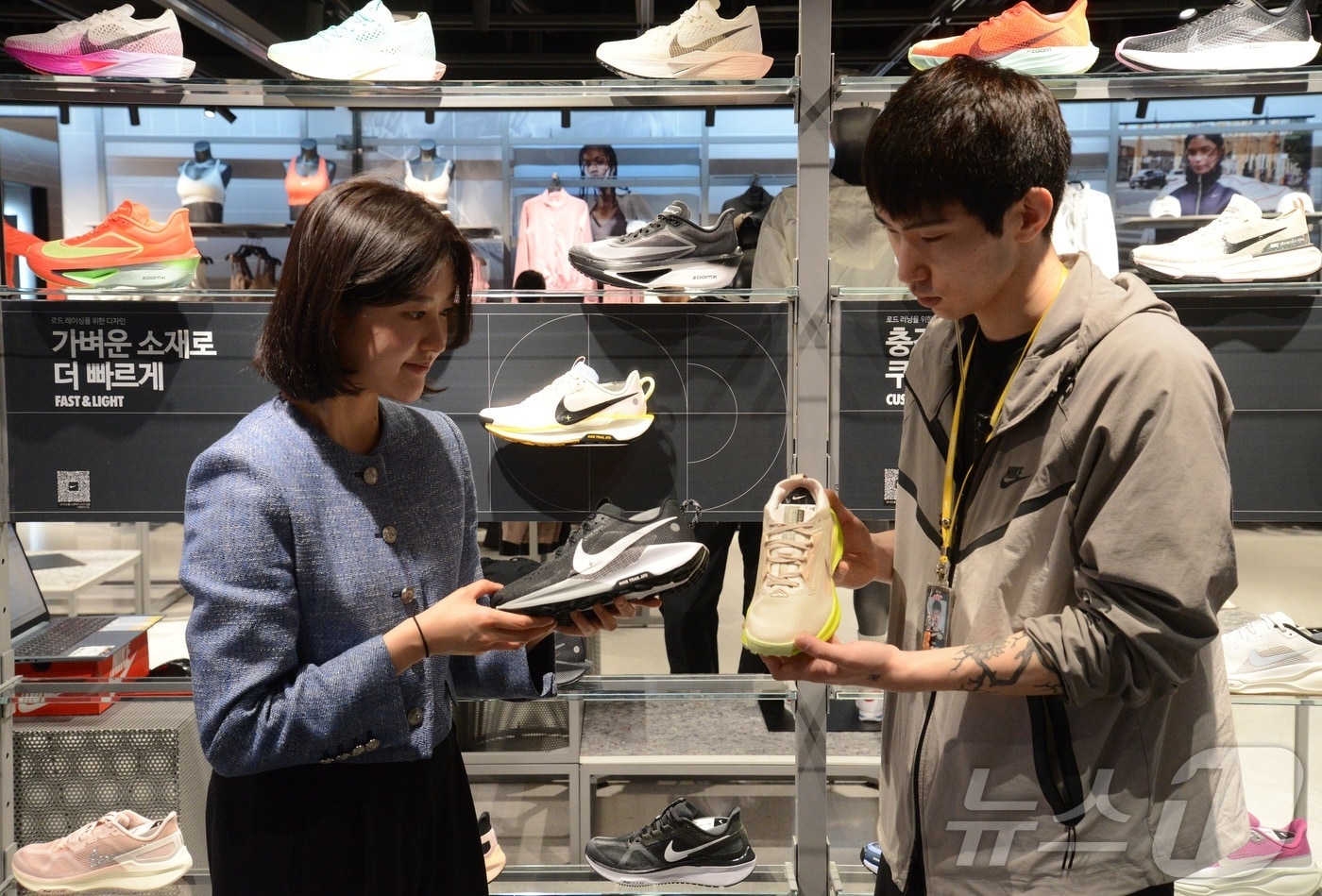 롯데백화점 부산본점 5층 나이키에서 직원이 고객에게 러닝화를 보여주고 있는 모습(롯데백화점 제공. 재판매 및 DB 금지)