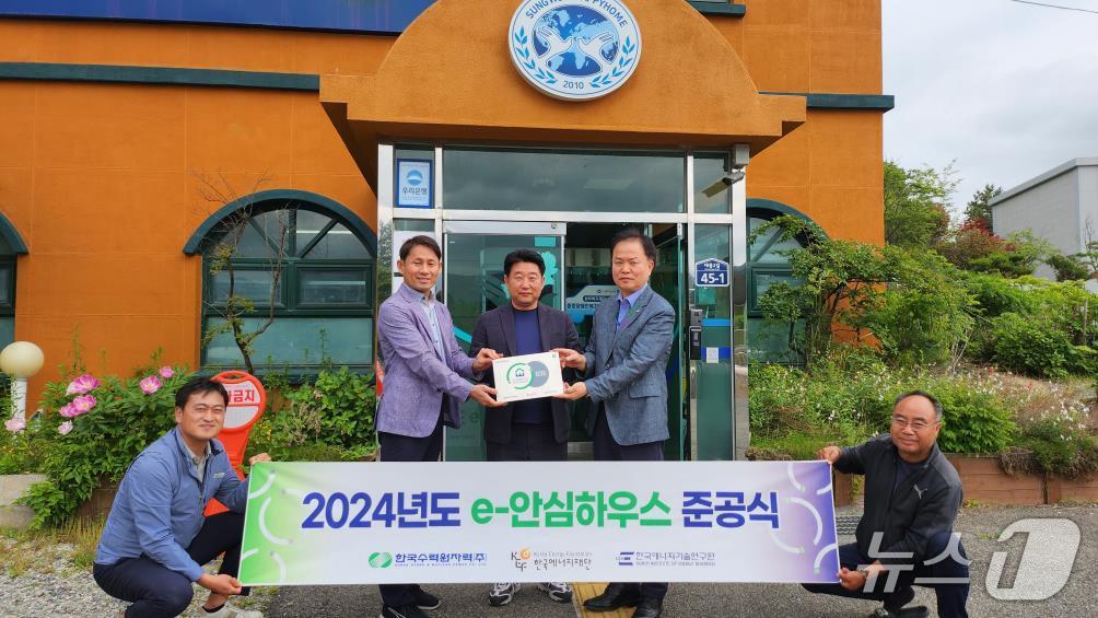 22일 ‘e-안심하우스’ 준공식에서 고리원자력본부 심준섭 지역협력부장(사진 오른쪽)과 한국에너지재단 장규식 팀장(왼쪽)이 성우해피홈 김준영 원장에게 'e-안심하우스' 현판을 전달하고 있다.(고리원자력본부 제공. 재판매 및 DB 금지)