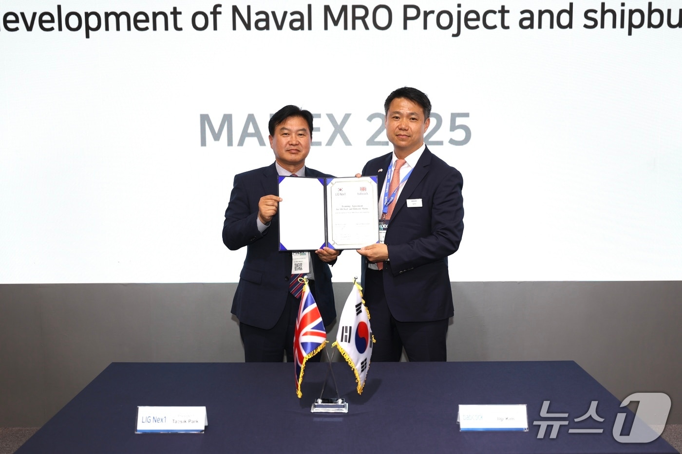 29일 국제해양방위산업전(MADEX 2025) 전시회 현장에서 ‘함정 MRO 사업개발 및 신규 함정 건조사업 공동참여 프로젝트 추진을 위한 협력합의서’를 체결한 박태식 LIG넥스원 미사일시스템사업부문장(좌측)과 일기 킴 밥콕 마린 최고영업책임자(우측)가 기념사진을 촬영하고 있다.(LIG넥스원 제공) 