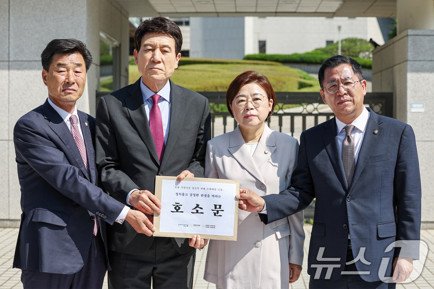 지진 피해에 대한 손해배상 소송의 대법원 심리를 앞둔 지난 11일 이강덕 포항시장(왼쪽 두번째)과 지역 정치권 인사들이 서울 서초구 대법원을 찾아 법원에 전달할 호소문을 보이고 있다.2025.6.11/뉴스1 ⓒ News1 민경석 기자