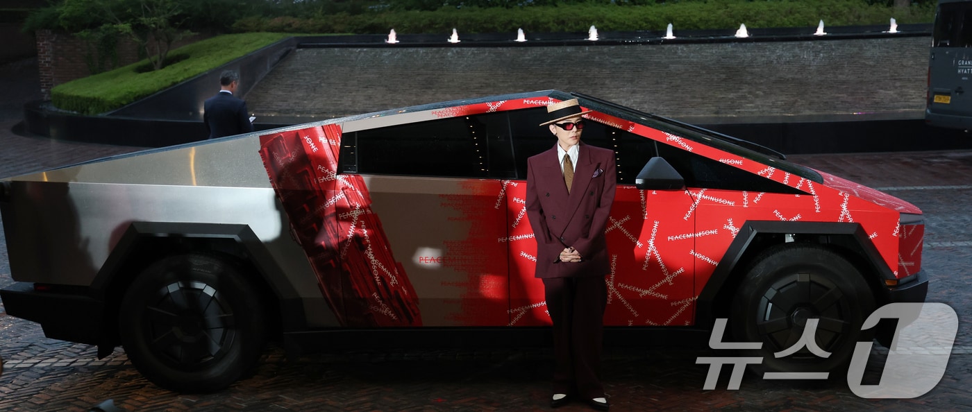 빅뱅 지드래곤(GD,권지용)이 13일 오후 서울 용산구 그랜드 하얏트 서울 호텔에서 열린 '피스마이너스원 프리미엄 하이볼 론칭 파티-더 시그널(THE SIGNAL)' 참석해 PEACEMINUSONE 로고가 새겨진 사이버트럭 앞에서 포즈를 취하고 있다. 2025.6.13/뉴스1 ⓒ News1 권현진 기자