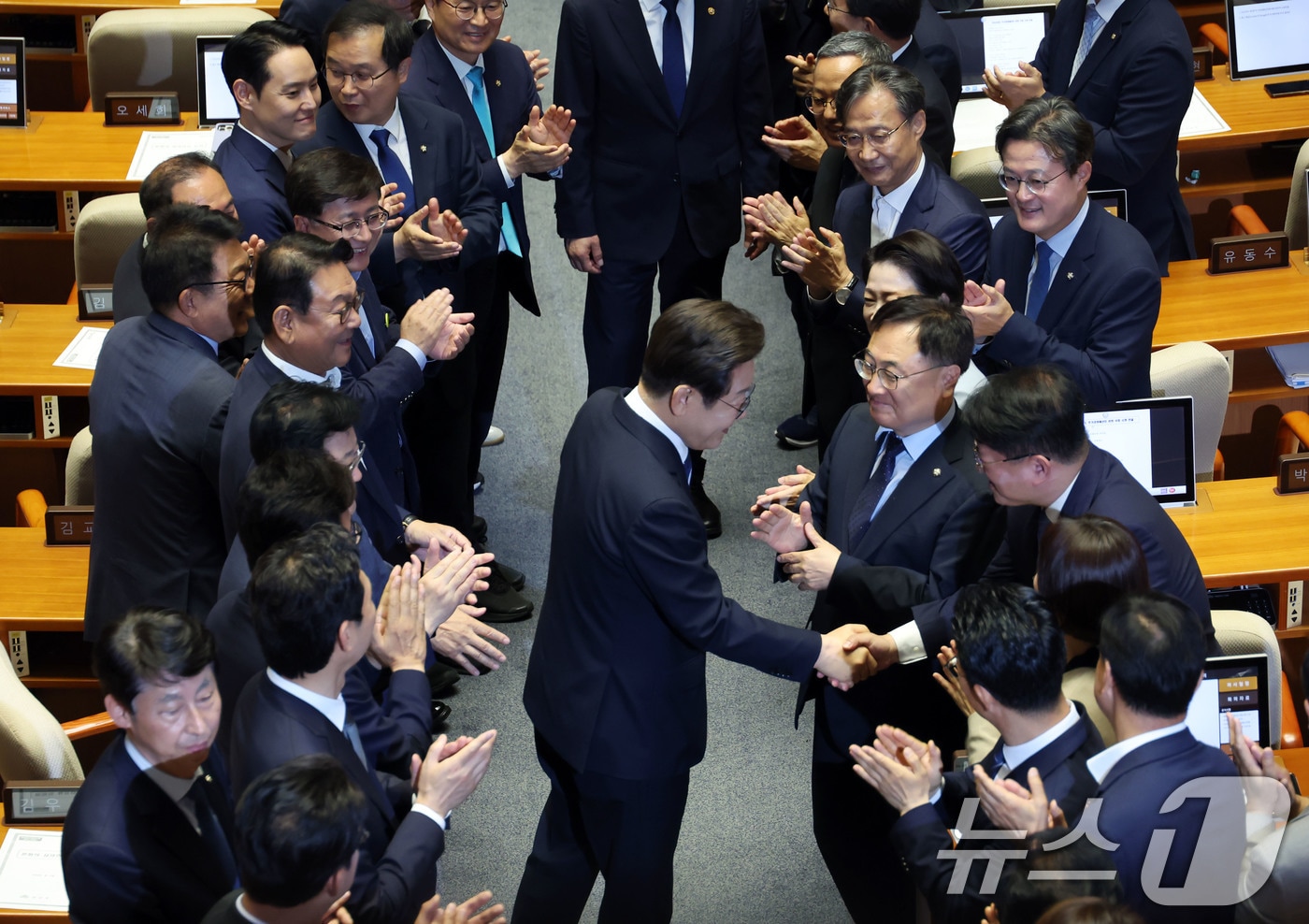 이재명 대통령이 26일 취임 이후 첫 추가경정예산안 시정연설을 위해 서울 여의도 국회 본회의장으로 입장하며 의원들과 인사나누고 있다. 2025.6.26/뉴스1 ⓒ News1 국회사진기자단