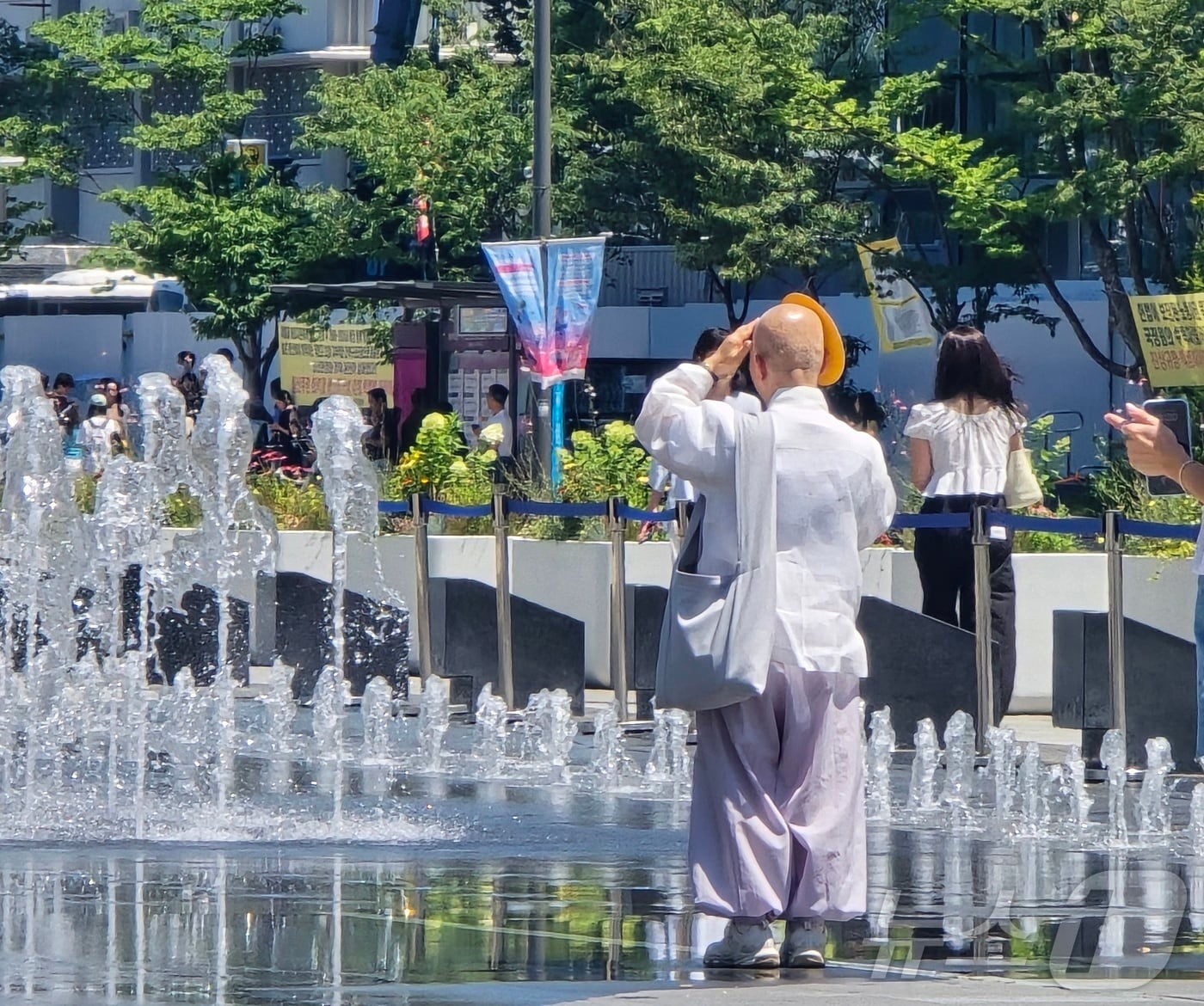11일 폭염 특보가 이어지는 서울 광화문에서 한 스님이 부채로 햇볕을 가리고 분수대를 바라보고 있다. 2025.7.11/뉴스1 ⓒ News1 황덕현 기후환경전문기자
