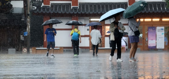 전북 전주시 한옥마을 태조로에서 우산을 쓴 관광객들이 발걸음을 재촉하고 있다. 2025.7.17/뉴스1 ⓒ News1 유경석 기자