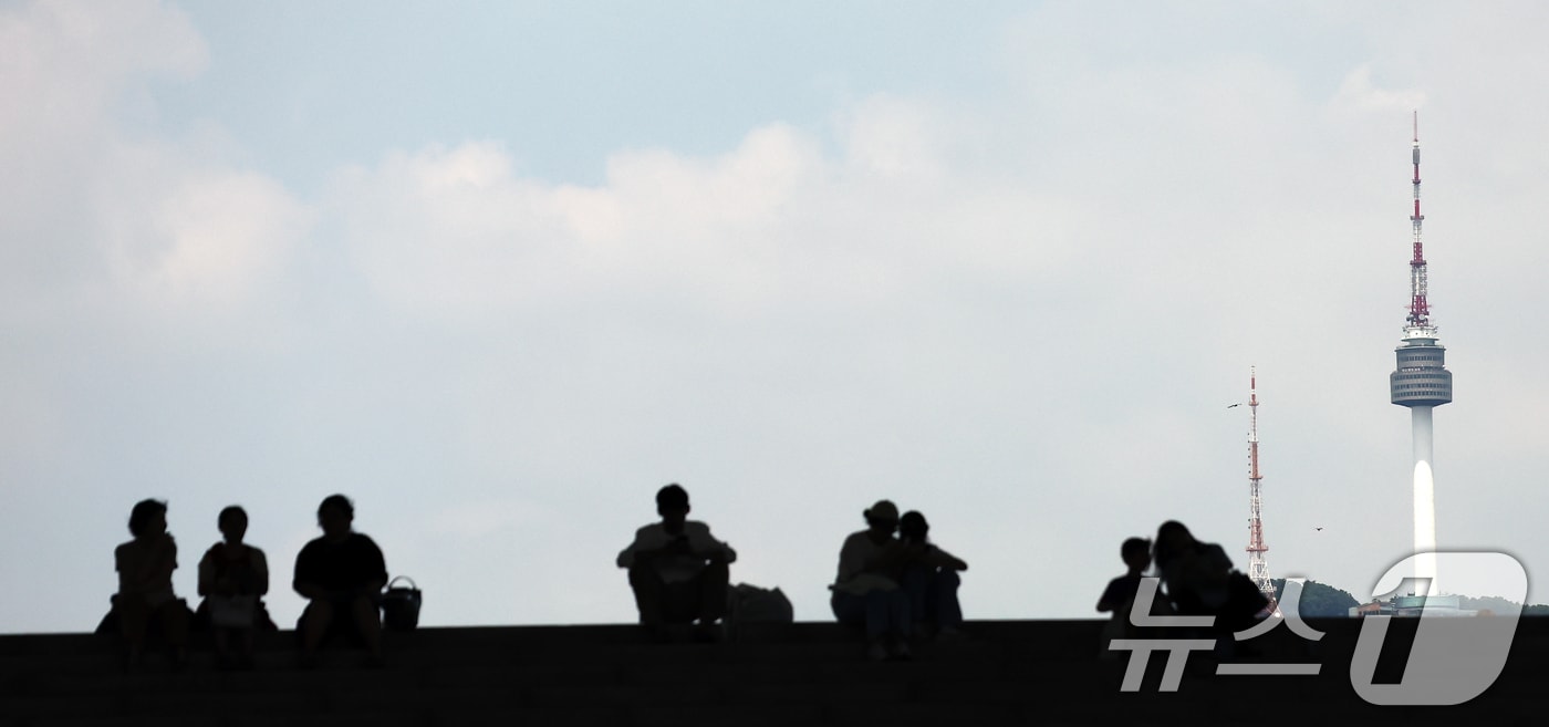 서울 전역에 폭염경보가 내려진 24일 서울 용산구 국립중앙박물관 계단에서 시민들이 파란 하늘을 보고 있다. 2025.7.24/뉴스1 ⓒ News1 김민지 기자