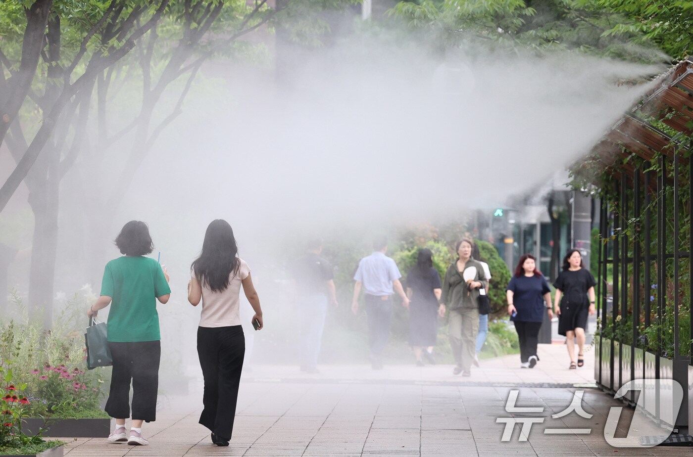 무더위가 이어지는 3일 오후 시민들이 서울광장에 설치된 쿨링포그 앞을 지나며 더위를 식히고 있다. 2025.7.3/뉴스1 ⓒ News1 구윤성 기자
