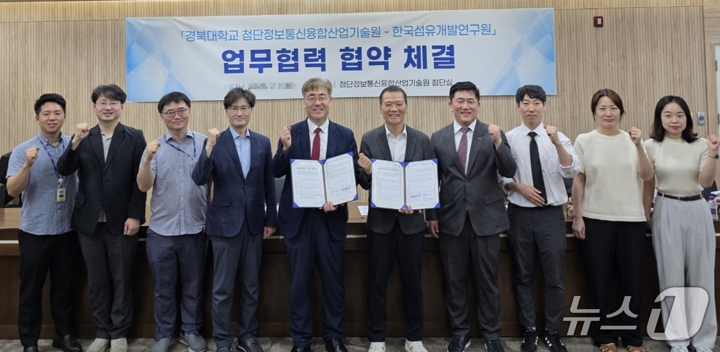 김현덕 첨단정보통신융합산업기술원장(왼쪽 다섯번째)과 김성만 한국섬유개발연구원장(오른쪽 다섯번째)이 공동 연구와 기술발전 촉진을 위한 업무협약을 체결한 뒤 직원들과 파이팅을 외치고 있다.(섬유개발연구원 제공. 재판매 및 DB 금지)