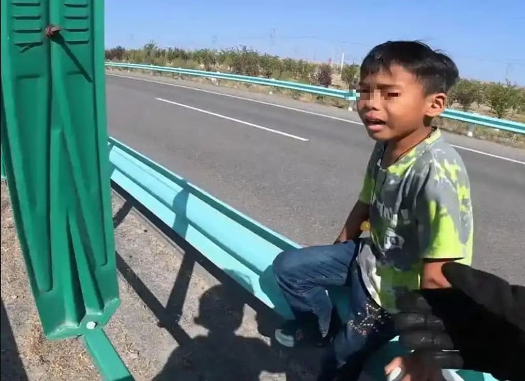 고속도로 대로변에 홀로 남겨진 남자아이. (SCMP 갈무리)