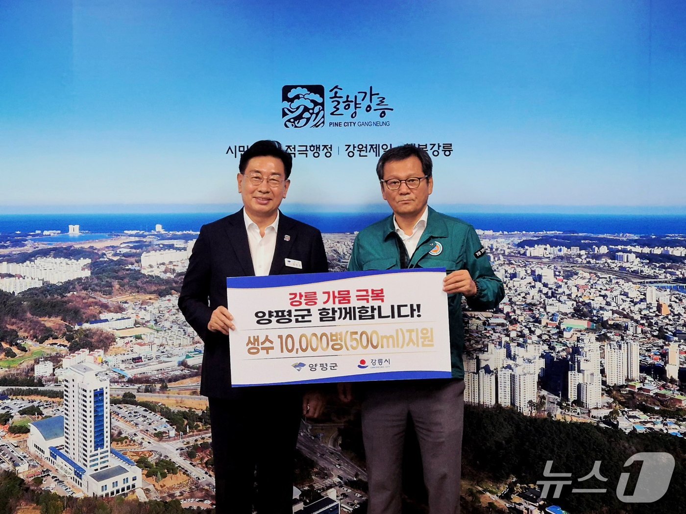 전진선 경기 양평군수(사진 왼쪽)가 29일 극심한 가뭄으로 큰 피해를 겪는 강원 강릉시에 물맑은양평수 1만병을 지원하고 기념사진을 찍고 있다.(양평군 제공. 재판매 및 DB 금지)/뉴스1