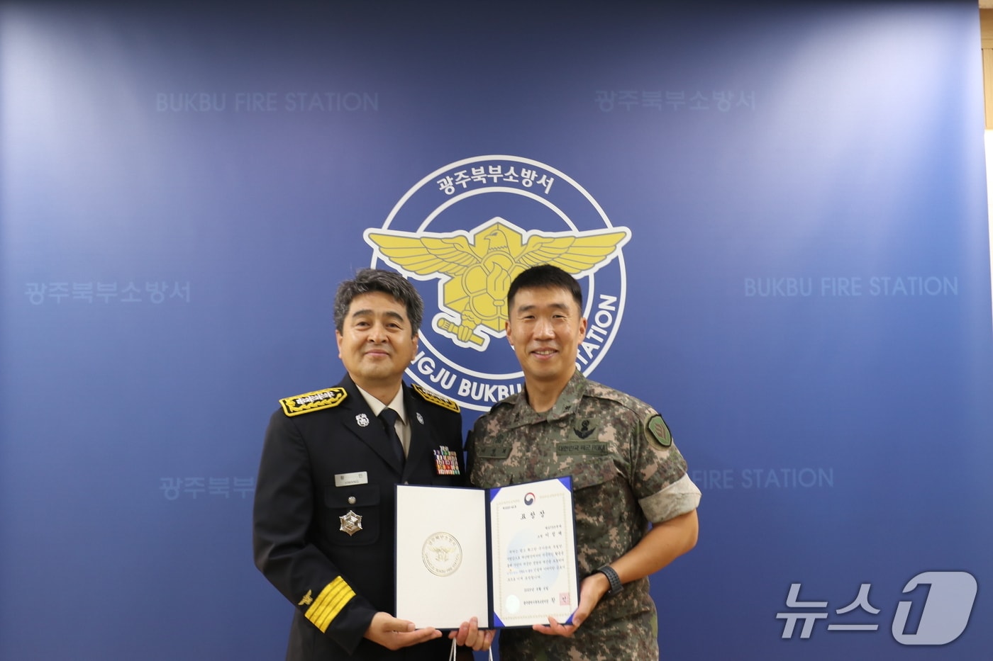 지난달 괴물폭우 속에 휩쓸릴 뻔한 대학생 2명을 무사 구조한 이정재 31사단 비호여단 소속 소령이 광주 북부소방서장으로부터 표창장을 수여받고 있다.(광주 북부소방서 제공) 2025.8.6