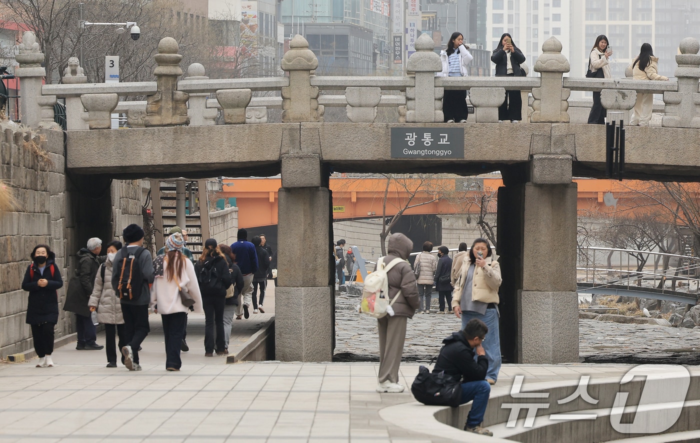서울 낮 최고 기온이 10도 이상 오르며 포근한 날씨를 보인 22일 오후 서울 청계천을 찾은 관광객들이 산책을 하고 있다. 2026.2.22 ⓒ 뉴스1 이호윤 기자
