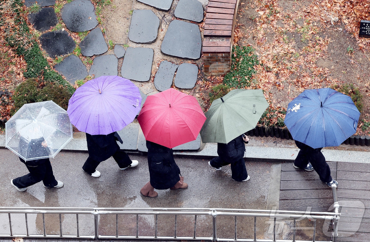 비가 내린 24일 광주 북구청 교차로에 공직자들이 우산을 쓰고 이동하고 있다.(광주 북구 제공. 재판매 및 DB 금지) 2026.2.24 