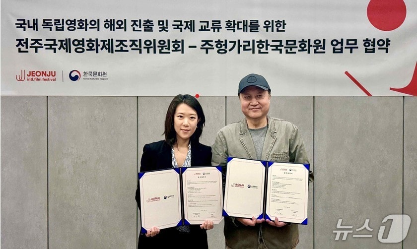 유혜령 주헝가리 한국문화원장과 민성욱 집행위원장이 업무협약을 체결하고 기념촬영을 하고 있다.(전주국제영화제 제공. 재판매 및 DB 금지)