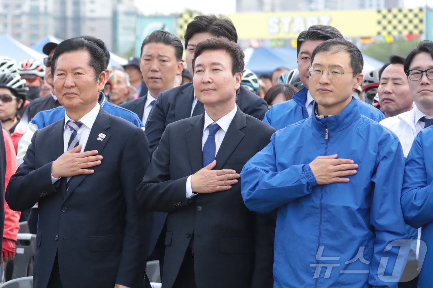 정청래 더불어민주당 대표(왼쪽)와 전태진 변호사(가운데), 김상욱 의원(오른쪽)이 18일 울산 태화강변 남구 둔치에서 열린 '울산 자전거 대축전'에 참석해 국민의례를 하고 있다. 2026.4.18 ⓒ 뉴스1 김세은 기자